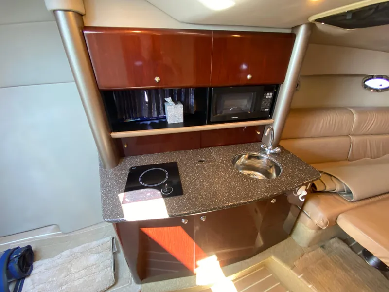 Slide: The Image of 2004 Formula 370 Super Sport interior kitchen with sink, stove, and microwave. - 22