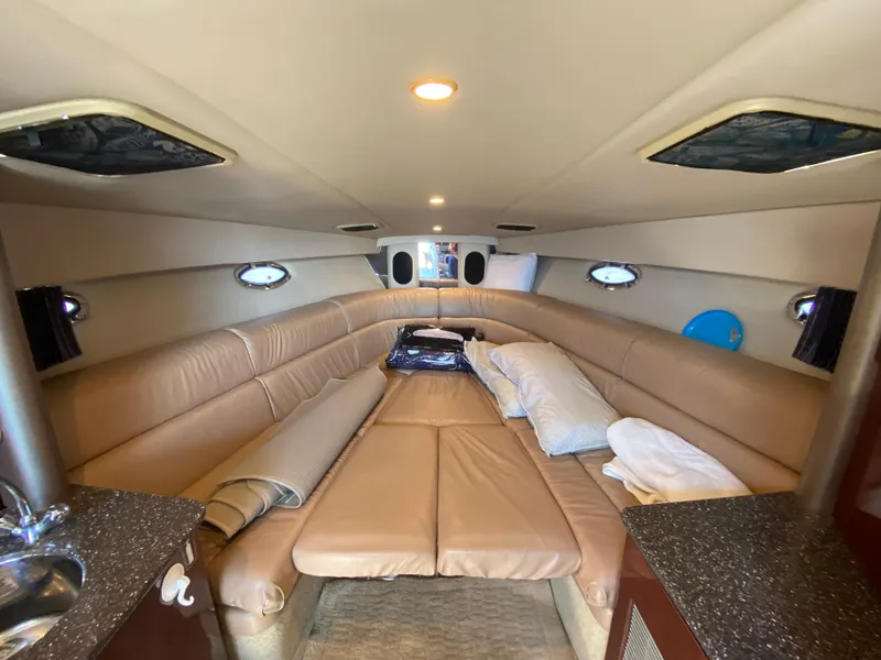 Slide: The Image of Interior cabin of a 2004 Formula 370 Super Sport boat with beige leather seating. - 25