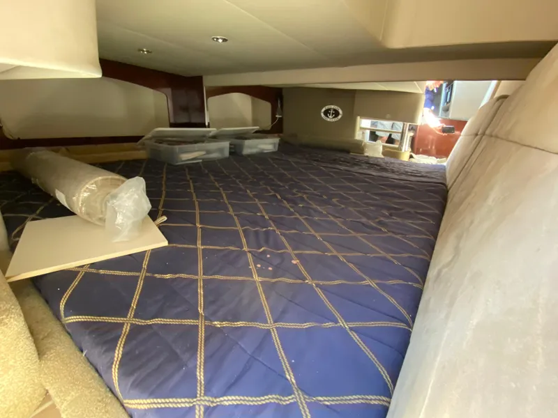 Slide: The Image of Interior cabin of a 2004 Formula 370 Super Sport boat with a blue quilted bed. - 27