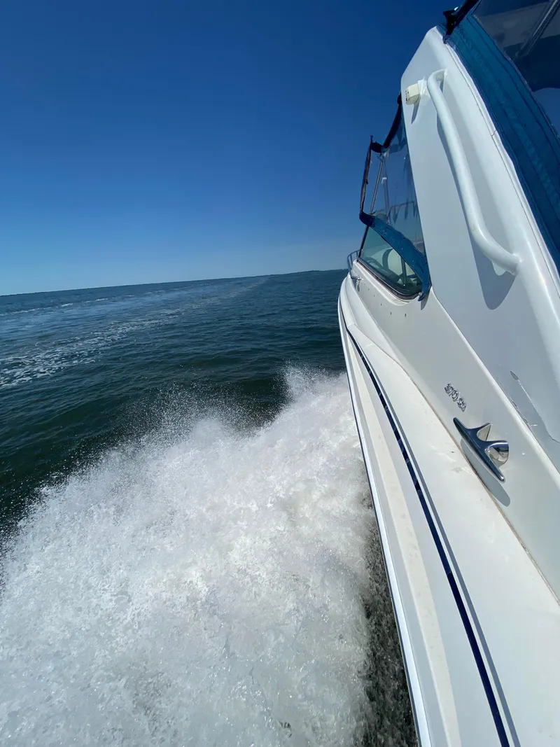 Slide: The Image of 2004 Formula 370 Super Sport boat cruising on open water. - 5