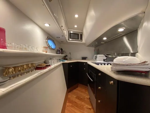 Slide: The Image of Luxurious kitchen interior of a 1995 Sunseeker MANHATTAN yacht with modern amenities. - 13