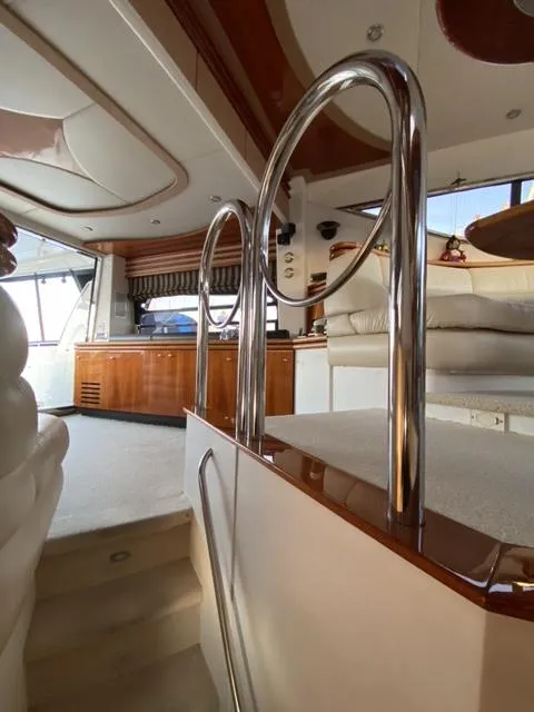 Slide: The Image of Interior of a 1995 Sunseeker Manhattan yacht, featuring elegant wood and chrome finishes. - 15