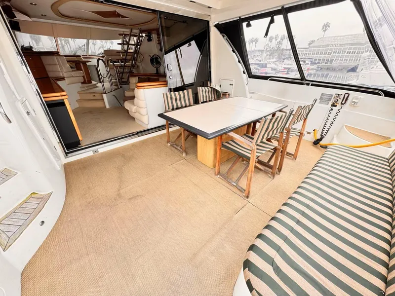 Slide: The Image of 1995 Sunseeker MANHATTAN yacht interior with dining area and striped seating. - 21