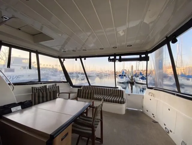 Slide: The Image of Interior of 1995 Sunseeker MANHATTAN yacht with seating and table, overlooking marina. - 23