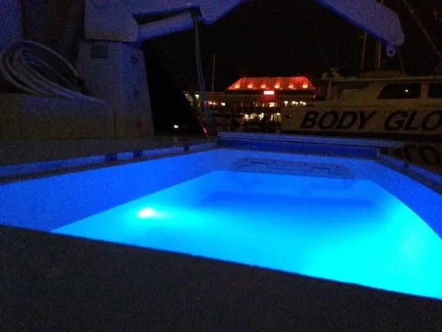 Slide: The Image of Sunseeker MANHATTAN 1995 yacht with illuminated blue pool at night. - 27