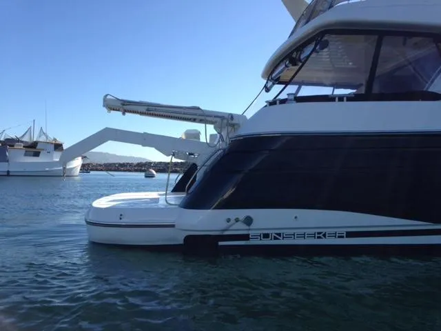Slide: The Image of 1995 Sunseeker MANHATTAN yacht docked in calm waters, side view. - 34