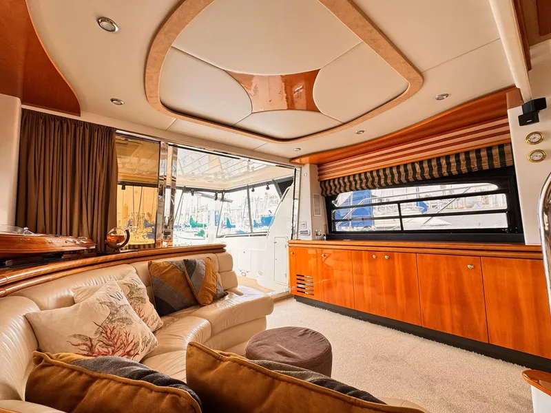 Slide: The Image of Luxurious 1995 Sunseeker MANHATTAN yacht interior with elegant wood finishes and plush seating. - 5