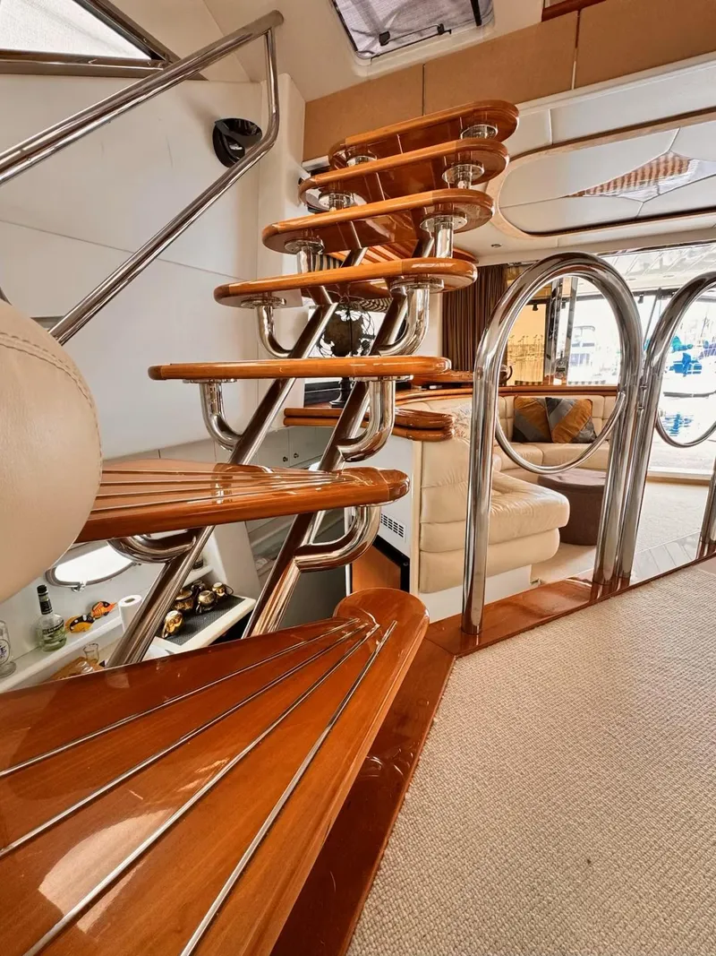 Slide: The Image of Interior of 1995 Sunseeker MANHATTAN yacht with elegant wooden staircase and modern design. - 9