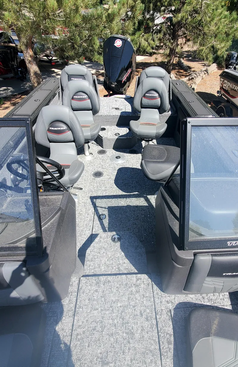 Slide: The Image of 2024 Tracker Targa V-19 Combo boat interior with seating and steering console. - 4