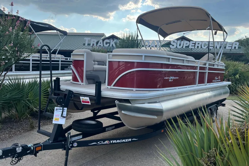 The Image of 2024 Sun Tracker Party Barge 24 DLX pontoon boat on trailer at dealership. - 0