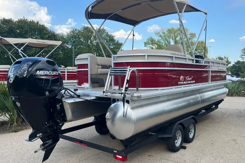 Slide: The Image of 2024 Sun Tracker Party Barge 24 DLX pontoon boat with Mercury engine on trailer. - 2