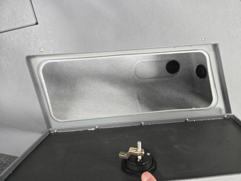 Slide: The Image of 2024 Princecraft Xpedition 200 storage compartment with a secure latch mechanism. - 19