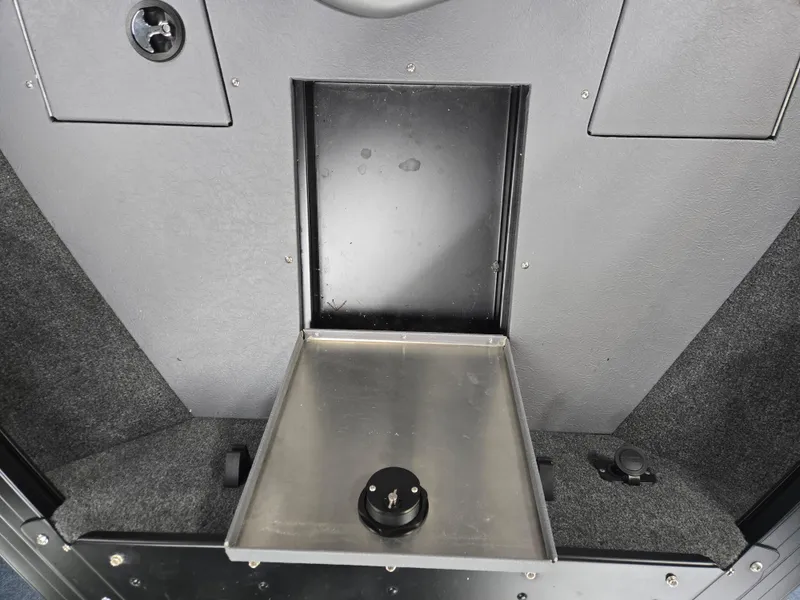 Slide: The Image of 2024 Princecraft Xpedition 200 boat interior storage compartment with metal tray and knob. - 20