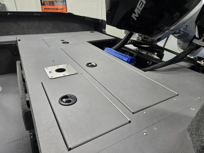 Slide: The Image of 2024 Princecraft Xpedition 200 boat interior with storage compartments and Mercury engine. - 7