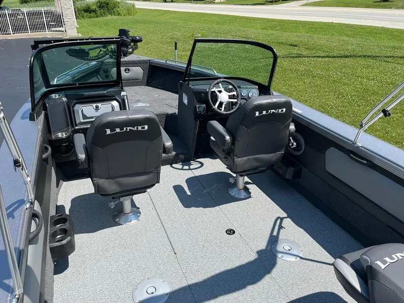 Slide: The Image of 2025 Lund 2275 Baron boat interior with two swivel seats and steering console. - 10