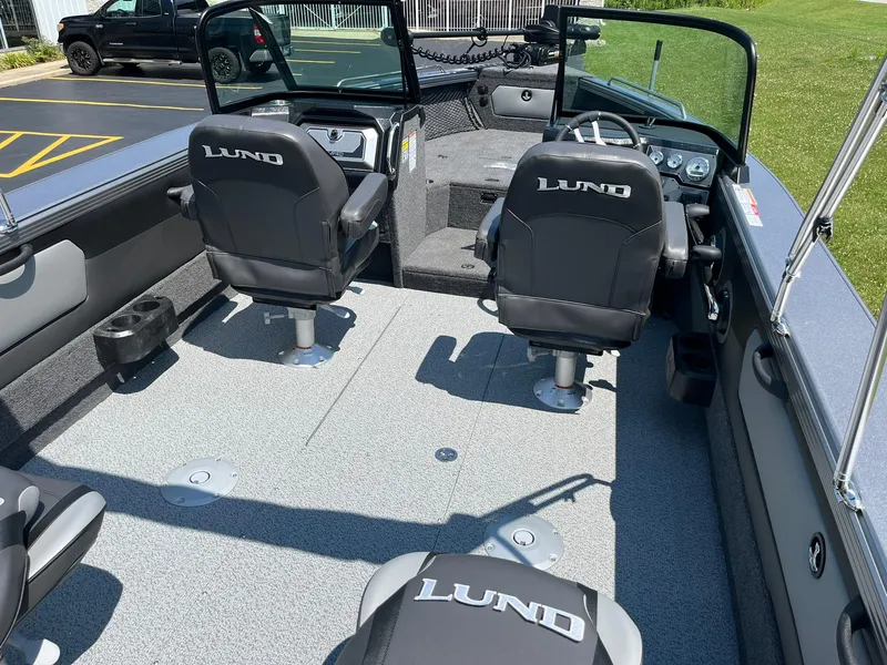 Slide: The Image of 2025 Lund 2275 Baron boat interior with seating and dashboard. - 12