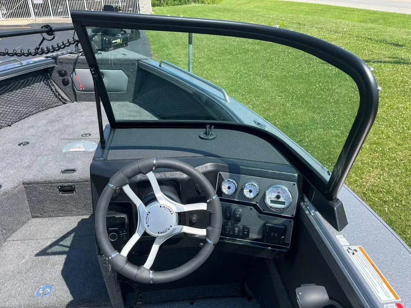 Slide: The Image of 2025 Lund 2275 Baron boat dashboard with steering wheel and gauges. - 22