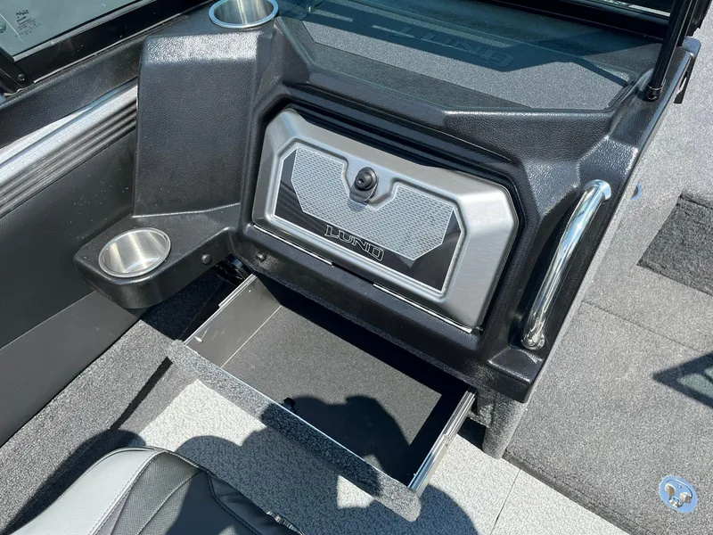 Slide: The Image of 2025 Lund 2275 Baron boat interior with storage compartment and cup holders. - 24