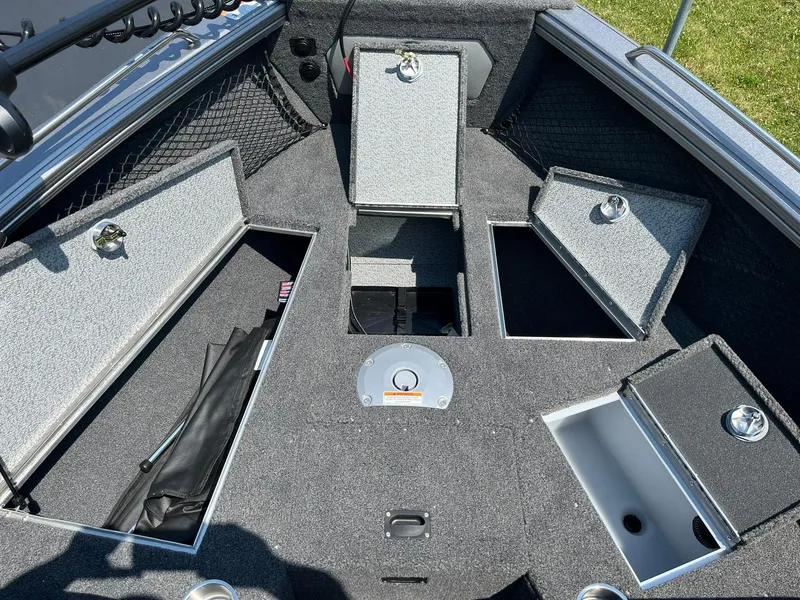 Slide: The Image of 2025 Lund 2275 Baron boat interior with open storage compartments. - 25