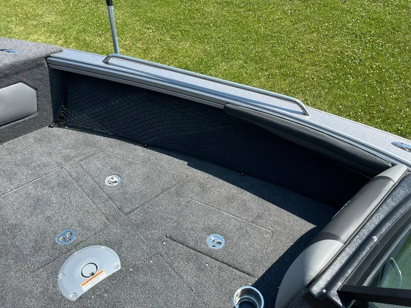 Slide: The Image of 2025 Lund 2275 Baron boat interior with gray carpet and seating. - 28