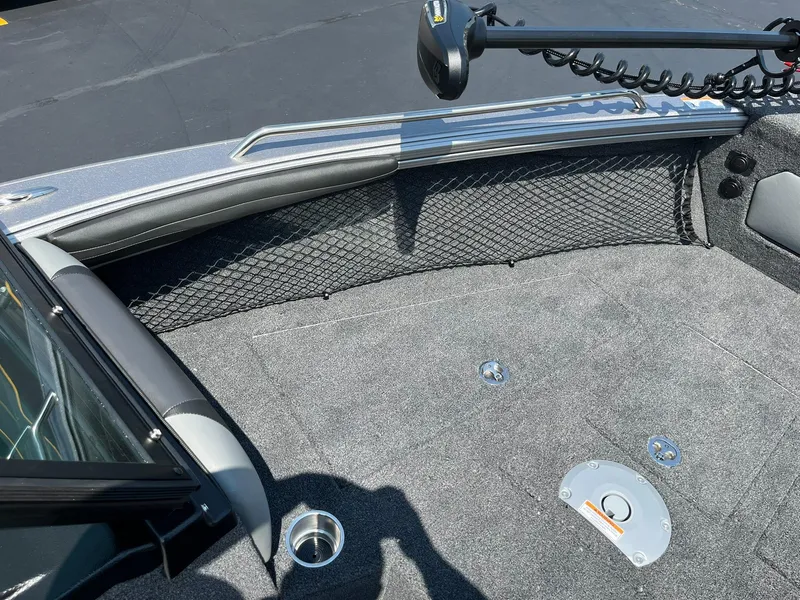 Slide: The Image of 2025 Lund 2275 Baron boat interior with carpeted deck and storage netting. - 29