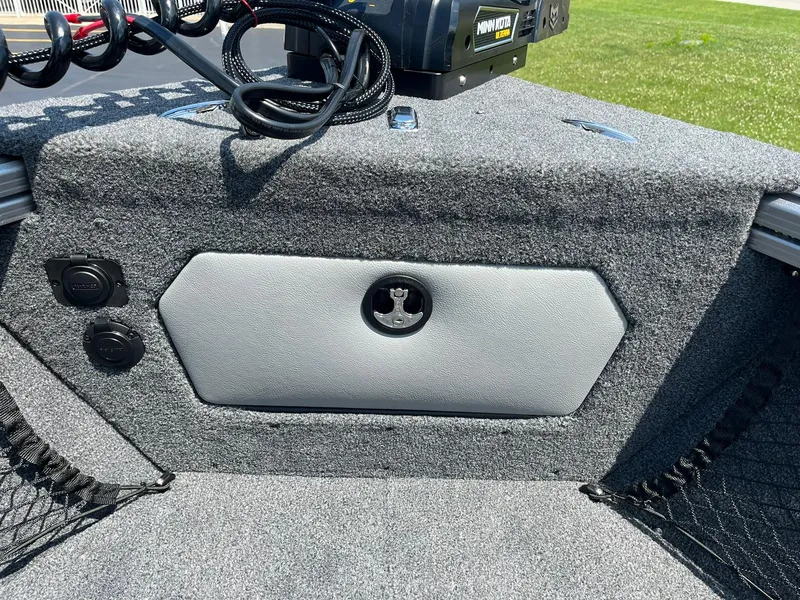 Slide: The Image of 2025 Lund 2275 Baron boat interior with storage compartment and fishing equipment. - 32