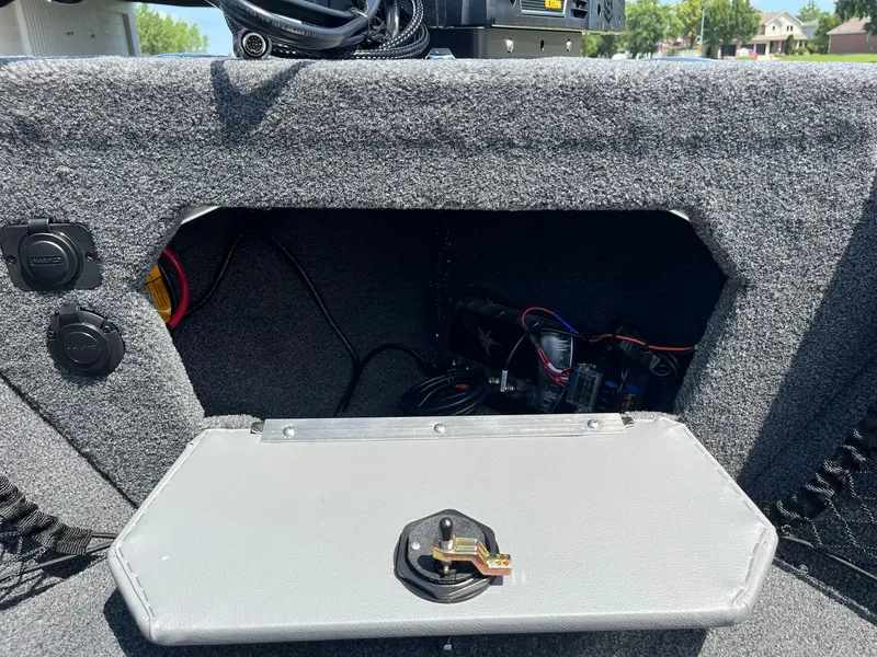 Slide: The Image of 2025 Lund 2275 Baron boat storage compartment with wiring and equipment. - 33