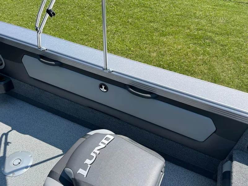 Slide: The Image of 2025 Lund 2275 Baron boat interior with seating and railing, featuring sleek design. - 38