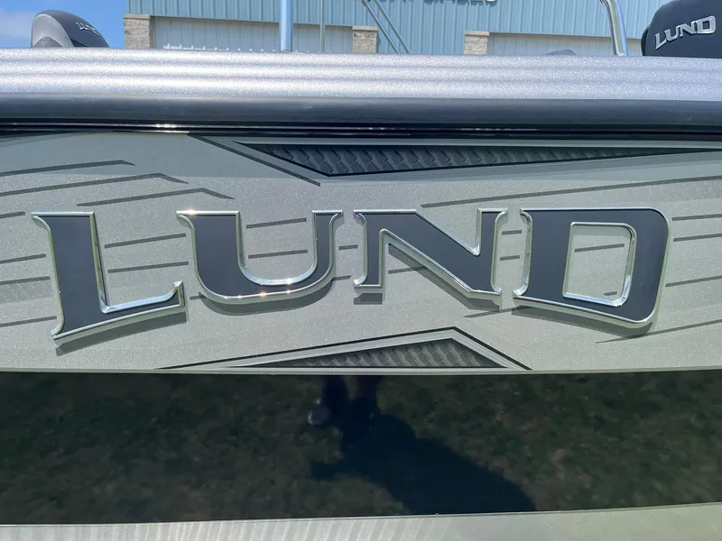 Slide: The Image of 2025 Lund 2275 Baron boat logo on sleek metallic surface. - 43