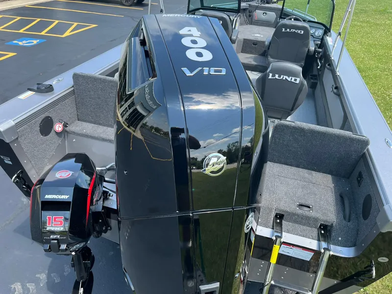 Slide: The Image of 2025 Lund 2275 Baron boat with Mercury 400 V10 and 15 engines, parked outdoors. - 45