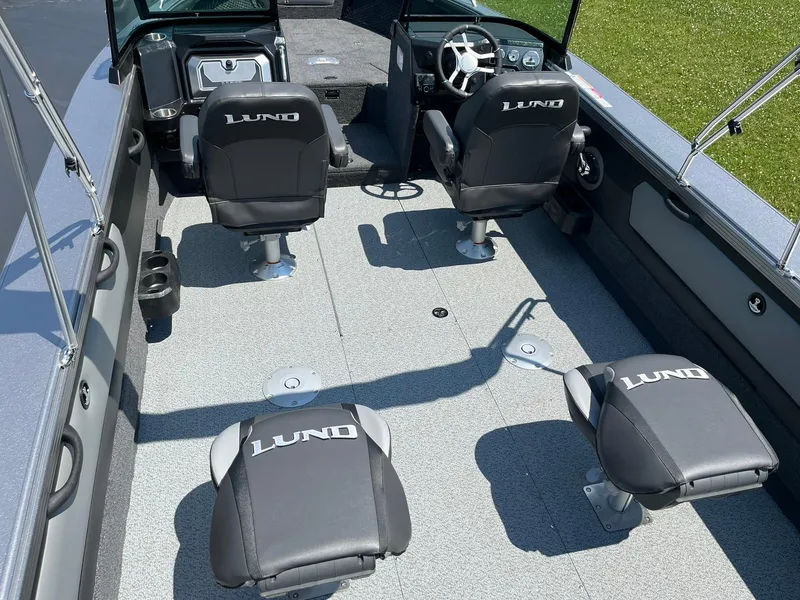 Slide: The Image of 2025 Lund 2275 Baron boat interior with four branded seats and steering console. - 8