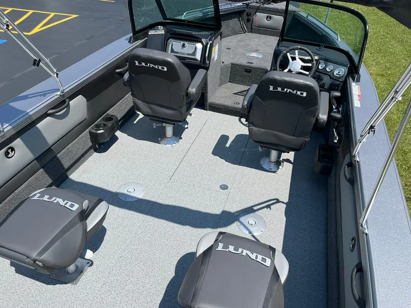 Slide: The Image of 2025 Lund 2275 Baron boat interior with four seats and steering console. - 9