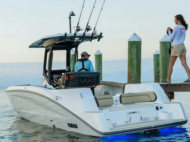 Slide: The Image of 2024 Yamaha Boats 255 FSH Sport H docked with fishing gear and passengers. - 4