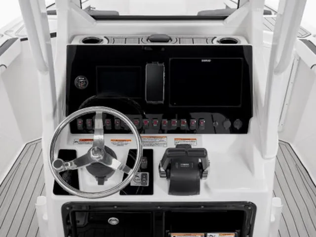 Slide: The Image of 2024 Yamaha Boats 255 FSH Sport E dashboard with steering wheel and controls. - 5