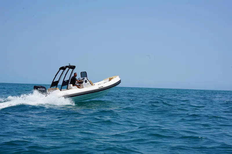 Slide: The Image of Aqvaboats Luxrib 19 (2025) speeding on open water. - 1