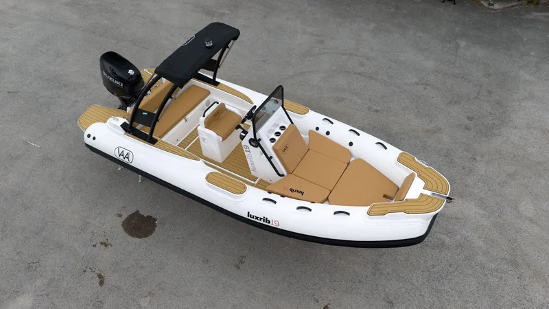 Slide: The Image of 2025 Aqvaboats Luxrib 19 inflatable boat with tan seating and black canopy. - 5