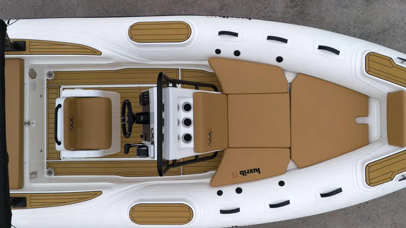 Slide: The Image of Top view of 2025 Aqvaboats Luxrib 19 inflatable boat with tan seating and white hull. - 8