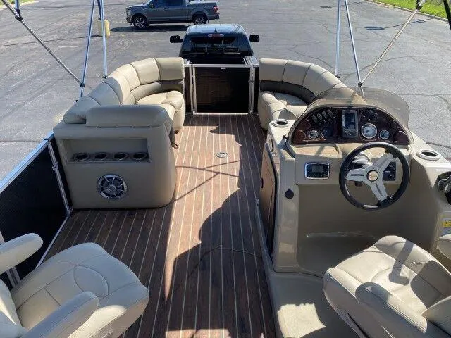 Slide: The Image of 2015 Silver Wave 250 Island SB Tri-Toon boat interior with beige seating and wood flooring. - 6