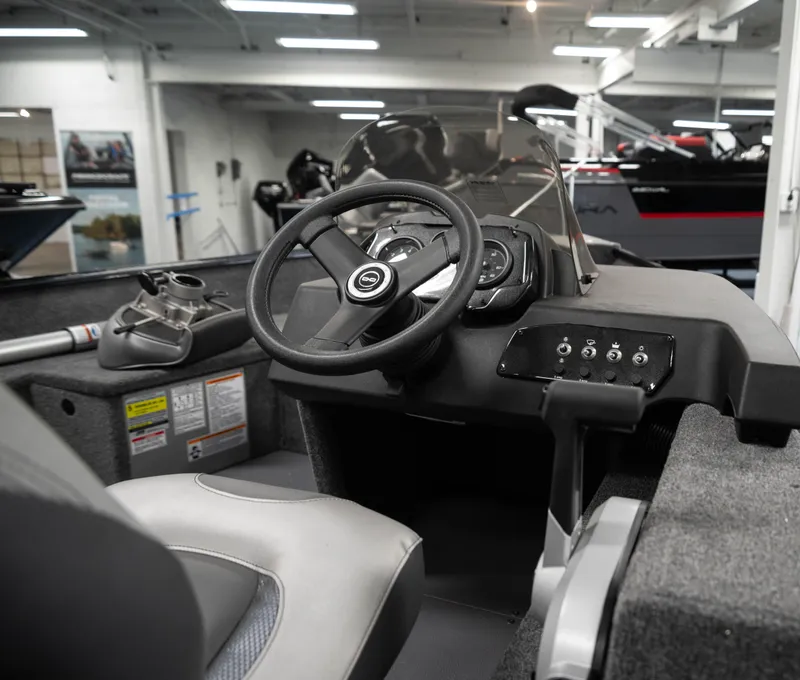 Slide: The Image of 2024 Princecraft Holiday 162 SC MAX boat interior, featuring steering console and seating. - 7