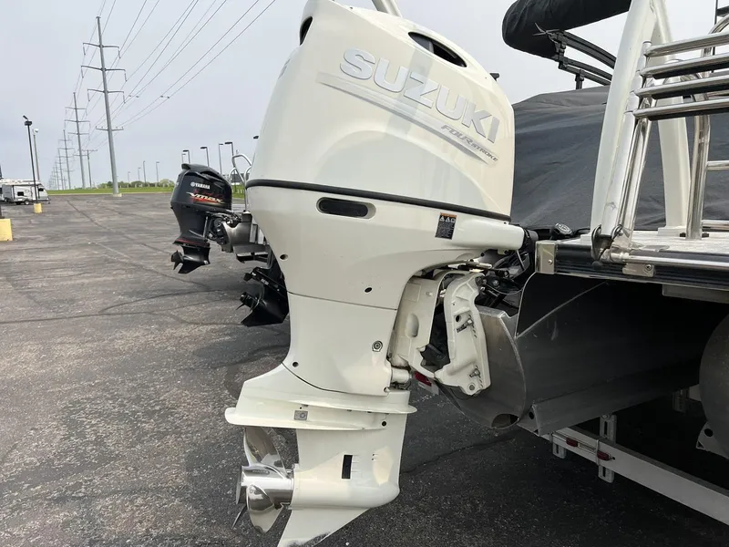 Slide: The Image of 2021 Berkshire 23 SB2 STS with Suzuki outboard motor in parking lot. - 11