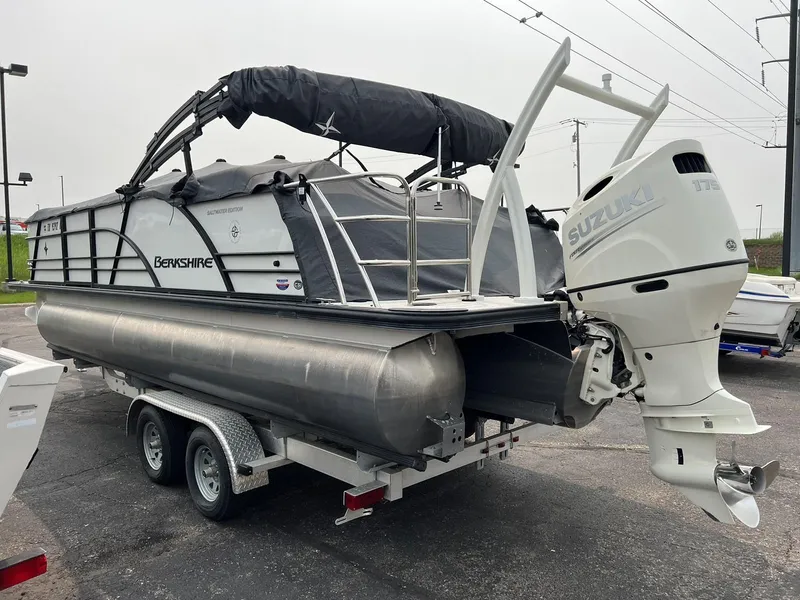 Slide: The Image of 2021 Berkshire 23 SB2 STS pontoon boat with Suzuki outboard motor on trailer. - 2