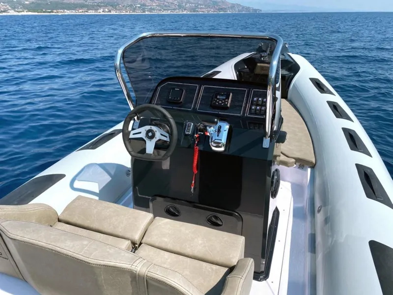 Slide: The Image of 2025 Ranieri CAYMAN 23 Sport boat on open water, featuring modern console and seating. - 12