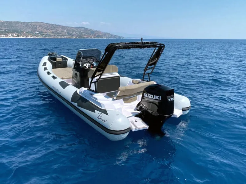 Slide: The Image of 2025 Ranieri CAYMAN 23 Sport boat on open water with Suzuki outboard motor. - 4