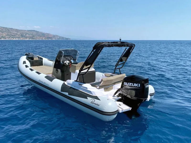 Slide: The Image of 2025 Ranieri CAYMAN 23 Sport boat with Suzuki outboard motor on open water. - 6