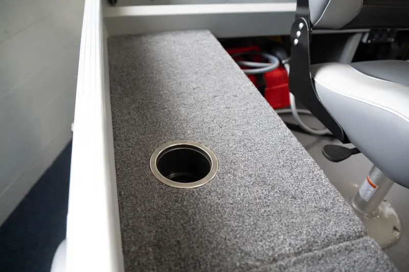 Slide: The Image of 2024 Princecraft Resorter 160 BT boat interior with carpeted bench and cup holder. - 10