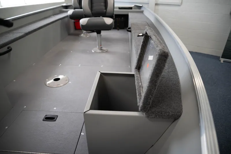 Slide: The Image of 2024 Princecraft Resorter 160 BT boat interior with storage compartment and seating. - 7