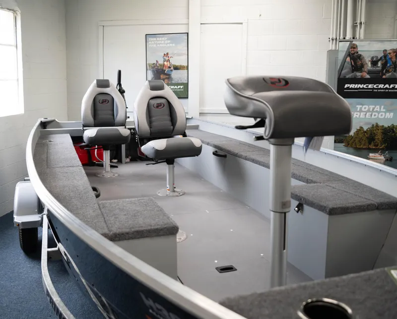 Slide: The Image of 2024 Princecraft Resorter 160 BT fishing boat interior with seating and storage. - 8