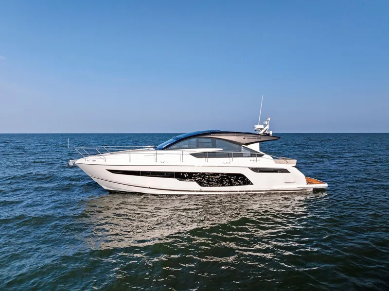 Slide: The Image of 2025 Fairline Targa 50 GT yacht cruising on open sea under clear blue sky. - 11