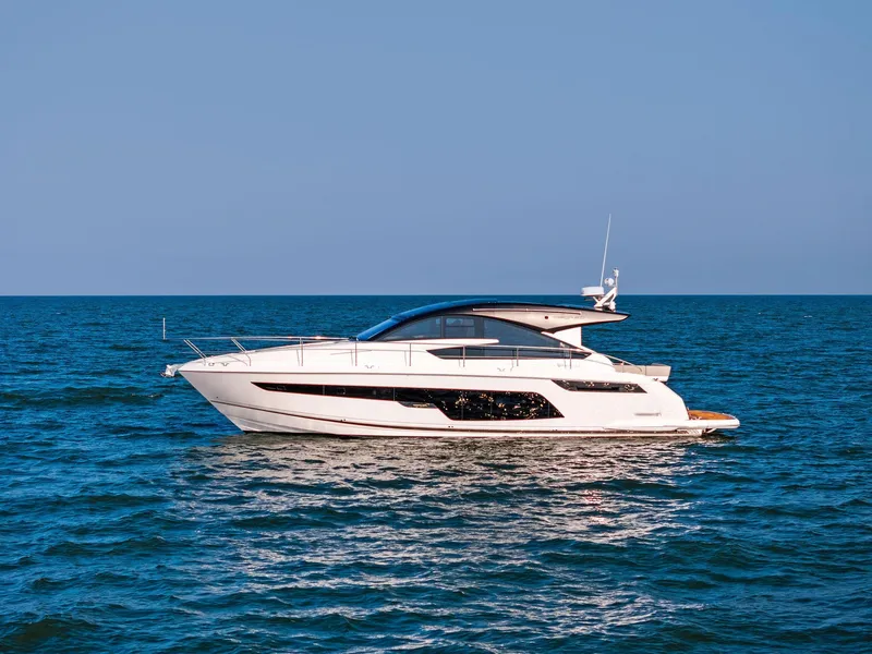 Slide: The Image of 2025 Fairline Targa 50 GT yacht cruising on open sea under clear blue sky. - 12