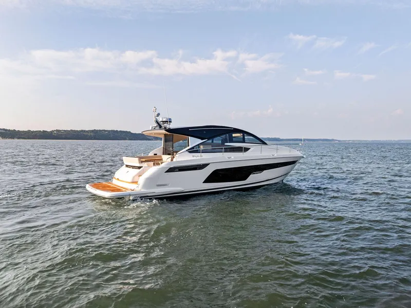 Slide: The Image of 2025 Fairline Targa 50 GT yacht cruising on open water under a clear sky. - 14